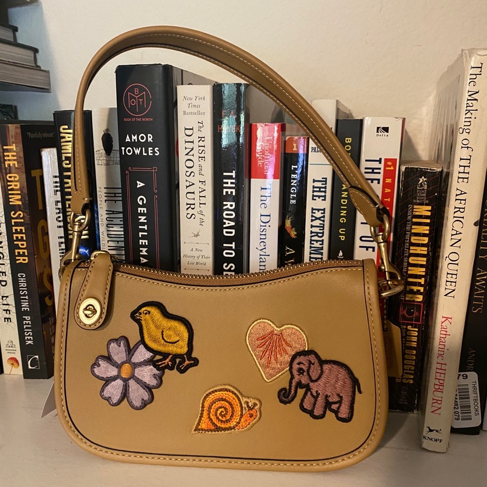 NWT Coach swinger 20 with creature patches